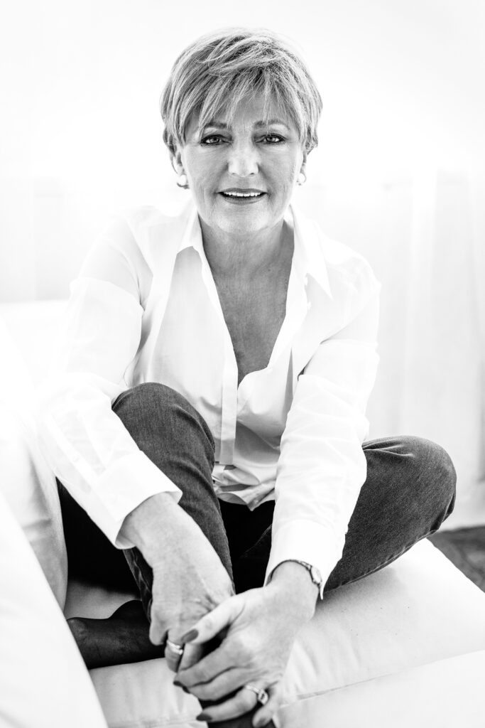 Seated short-haired woman in a white shirt – portrait photography by Takács Bori, Budapest