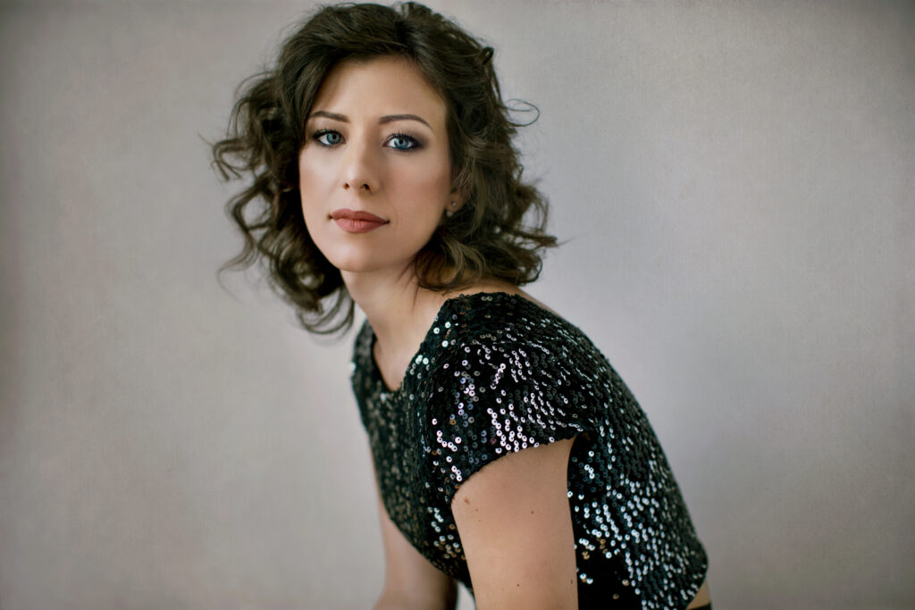 Curly dark-haired woman in a sequined top – glamour photography by Takács Bori, Budapest