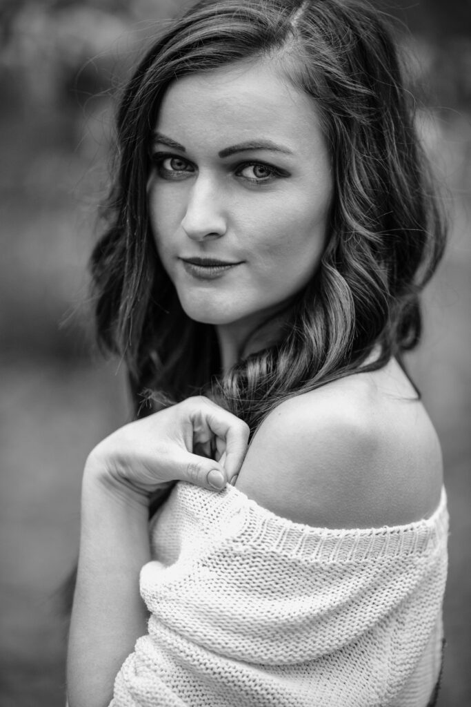 Black-and-white portrait of a woman in a white sweater – portrait photography by Takács Bori, Budapest