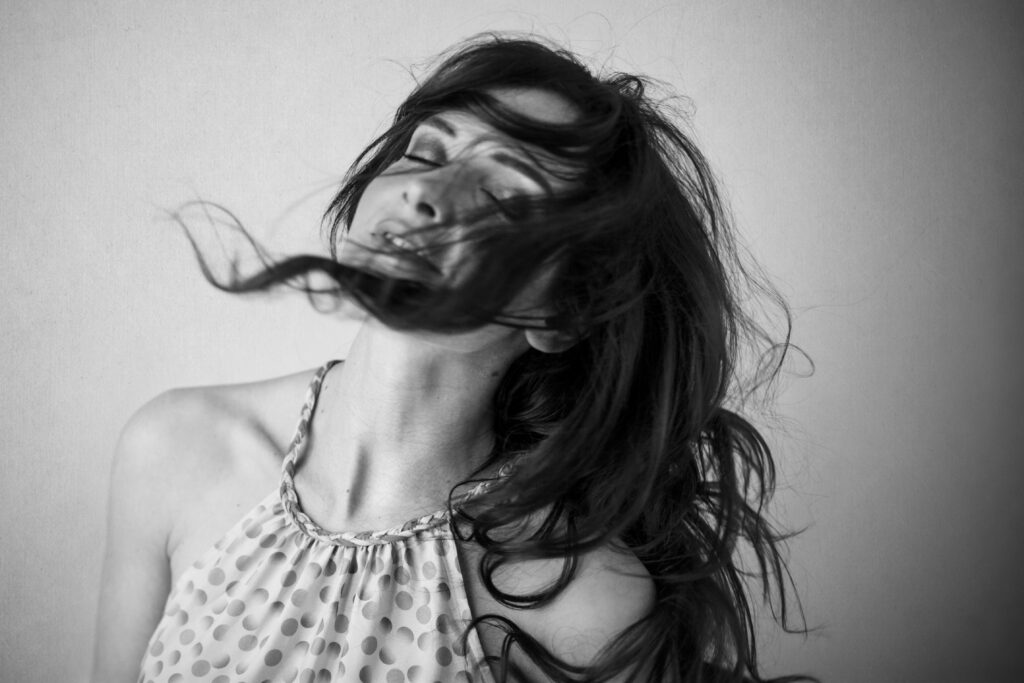 Black-and-white image of a woman with windswept hair – portrait photography by Takács Bori, Budapest