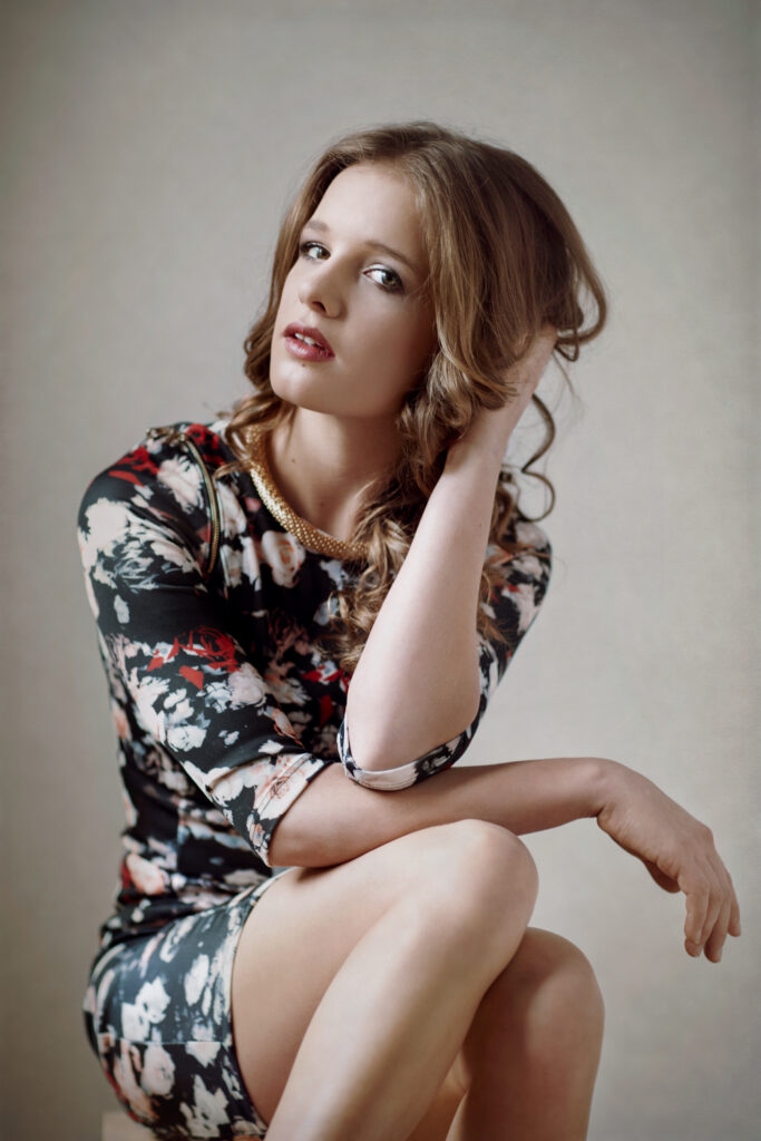 Seated woman in a patterned dress – glamour photography by Takács Bori, Budapest
