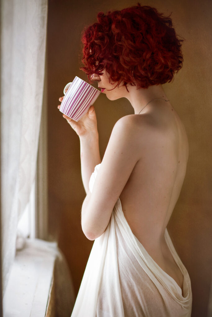 Red-haired woman by the window – boudoir photography by Takács Bori, Budapest